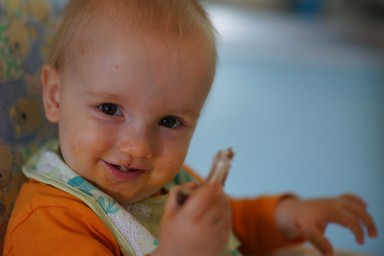My 14 month old grandson at his home at Huia. A typical cheeky look that he gets when messing with food.